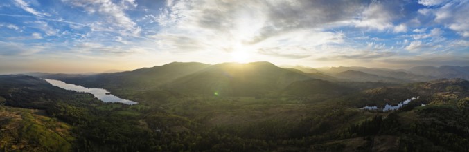 Panorama of Sunset over Mountains and Coniston Water from drone, Lake District National Park,