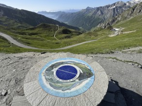 In front orientation board at viewpoint on third highest asphalted pass in the Alps highest border