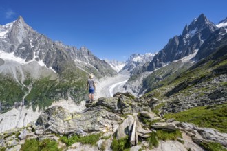Picturesque mountain landscape with imposing mountain peaks and glaciers, mountaineer on hiking