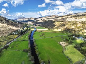 Farms and Mountains over River Dochart and Road A85 from a drone, Perthshire, Scotland, UK
