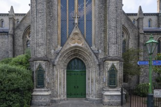 Neo-Gothic church entrance with green door, St James's Church, Norlands, architects Lewis Vulliamy,