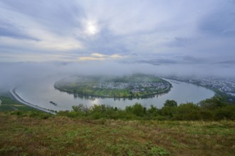 Foggy river bend, surrounded by green hills and calm morning atmosphere, summer, Rhine bend