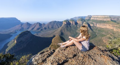 Hiker enjoying sunset at Blyde River Canyon with Three Rondawels peak, view of canyon with Blyde