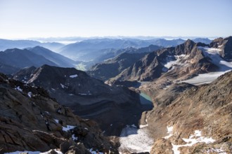 View of mountain panorama into the Ridnaun valley with blue glacier lake, ascent to the Wilder