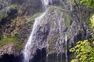 Elevated view of the Urach waterfall flowing over moss-covered rocks, Bad Urach