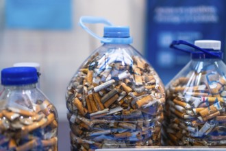 Plastic bottles filled with cigarette butts highlighting environmental pollution and the need for