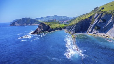 Breathtaking aerial view of the unique flysch cliffs meeting the deep blue water of the cantabrian