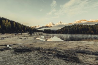 Lake Staz near Sankt Moritz in the Engadin in Switzerland. Morning atmosphere with fog in autumn.