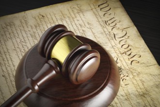 United states constitution and gavel resting on table