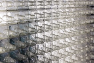 Wall of empty glass whiskey bottles at the Visitor Center of the Jack Daniel Distillery in