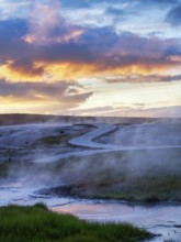 Curved wooden path, sulphur vapour, Hveravellir geothermal area, sunset, Icelandic highlands,