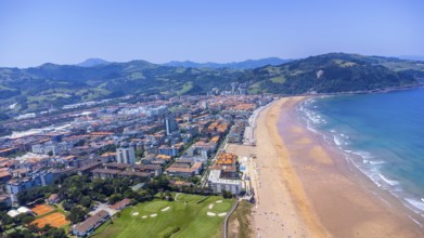 Aerial perspective of zarautz, gipuzkoa, showcasing the urban landscape meeting the sandy beach and