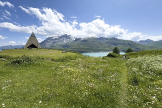 Panoramic view from plateau above Lanslebourg-Mont-Cenis to reservoir Lac du Mont Cenis left Museum