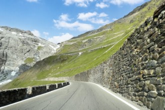 View of east ramp ascent to descent from Alpine pass Stelvio Stilfserjoch mountain road above tree