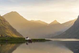Landscape with sea and mountains on the Lofoten Islands. The fjord Flakstadpollen and some houses
