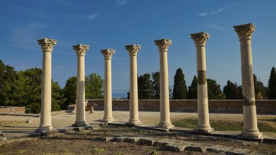Six ancient columns with capitals in front of a clear sky, part of a historical site, Temple of