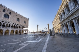 Chairs and tables of cafes at Piazetta San Marco, Doge's Palace and Colonna di San Marco and