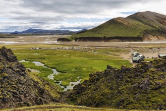 Hiking trail through volcanic landscape, lava rock, view of the campsite in Landmannalaugar,