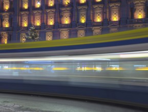 Tram at Night in Bahnhofstrasse and Illuminated Building in Long Exposure in a Winter Night in City