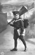 School enrolment, 1920s, A boy in school uniform with school bag and cone in a studio, Historical
