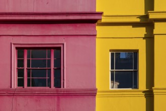 Colourful building facades in pink and yellow, Portobello Road, Notting Hill, London, England,