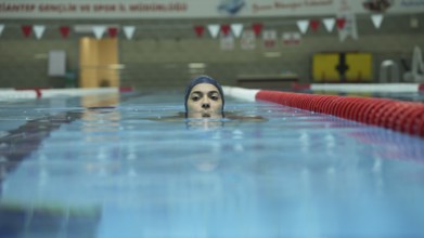 Amputee swimming in an Olympic pool
