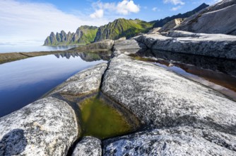 Reflection in a tidal pool, rocky coast of Tungeneset, Devil's Teeth, Okshornan, Ersfjorden, Senja