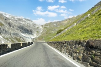 View of east ramp ascent to descent from Alpine pass Stelvio Stilfserjoch mountain road above tree