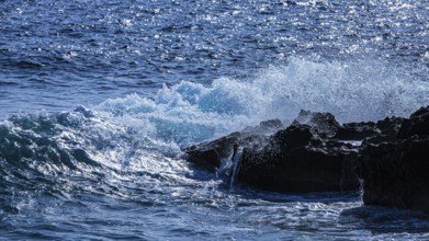 Rugged rocky coastline and foaming spray, on Stecci beach, near Capoliveri, Elba Island, Tuscan