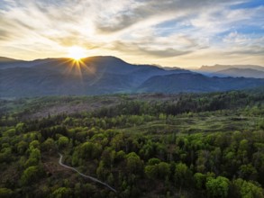 Sunset over Mountains and Coniston Water from drone, Lake District National Park, Cumbria, England,