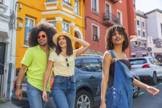 Happy friends enjoying a summer journey together, walking down a vibrant street with colorful