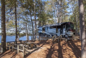 Motorhome parked on the shores of Archusa Creek Lake in Archusa Creek Water Park near Quitman,
