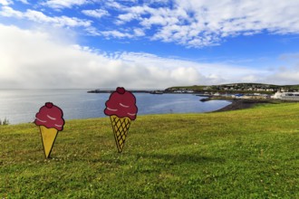 Two ice-cream cones in summer, signs in a meadow by the sea, fun decoration on Candy Day, Cumulus,