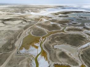 Desert-like scenery with rivers and salt flats, a barren, wide landscape, aerial view, salt lake,