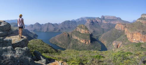 Hiker enjoying panorama, Blyde River Canyon with summit Three Rondawels, view of canyon with river