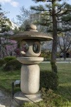 Toro stone lantern in Shukkei-en in spring, historical Japanese strolling garden, Japanese garden,