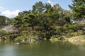 Shukkei-en with Sekisui-gan stone formation and Takuei-chi pond in spring, historical Japanese