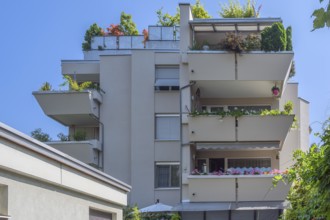 Grey façade, green flat roof and concrete balconies with floral decorations, Dornbirn, Vorarlberg,