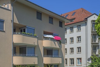 Grey-yellow facades with green concrete balconies and sunshades, Dornbirn, Vorarlberg, Austria