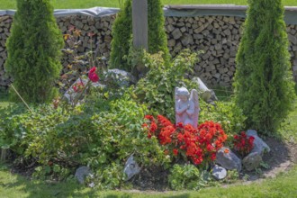 Flower bed with angel, Frauenzel, Allgäu, Bavaria, Germany