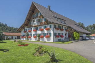 Renovated farmhouse with floral decorations, Frauenzel, Allgäu, Bavaria, Germany
