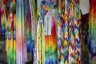 Chains of colourful origami cranes made of paper as a sign of peace in the Peace Park, landmark,