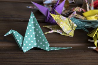 Colourful origami cranes made of paper as a sign of peace in the Peace Park, close-up, landmark,