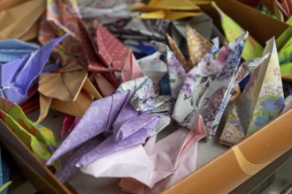 Colourful origami cranes made of paper as a sign of peace in the Peace Park, close-up, background