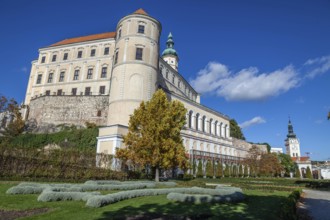 A majestic castle with a well-tended garden stretches out under a clear blue sky, Mikulov