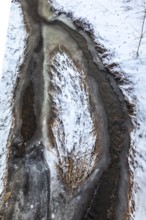 Aerial view of a partially frozen stream surrounded by snow, Kamptal Waldviertel Austria