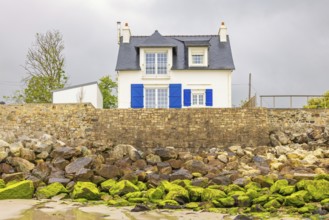 Cute residential house by the beach on a stone pier, Morgat, Crozon peninsula, Bretagne, France