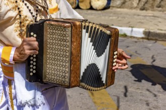 Accordionist with his instrument at the Congado festival in Minas Gerais, Belo Horizonte, Minas