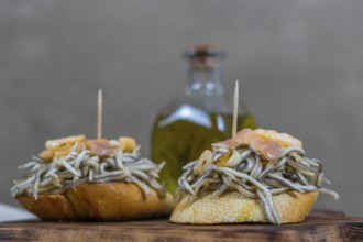 Gulas with garlic prawns in earthenware casserole dish