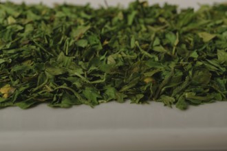 Close-up of dried parsley on a white dish
